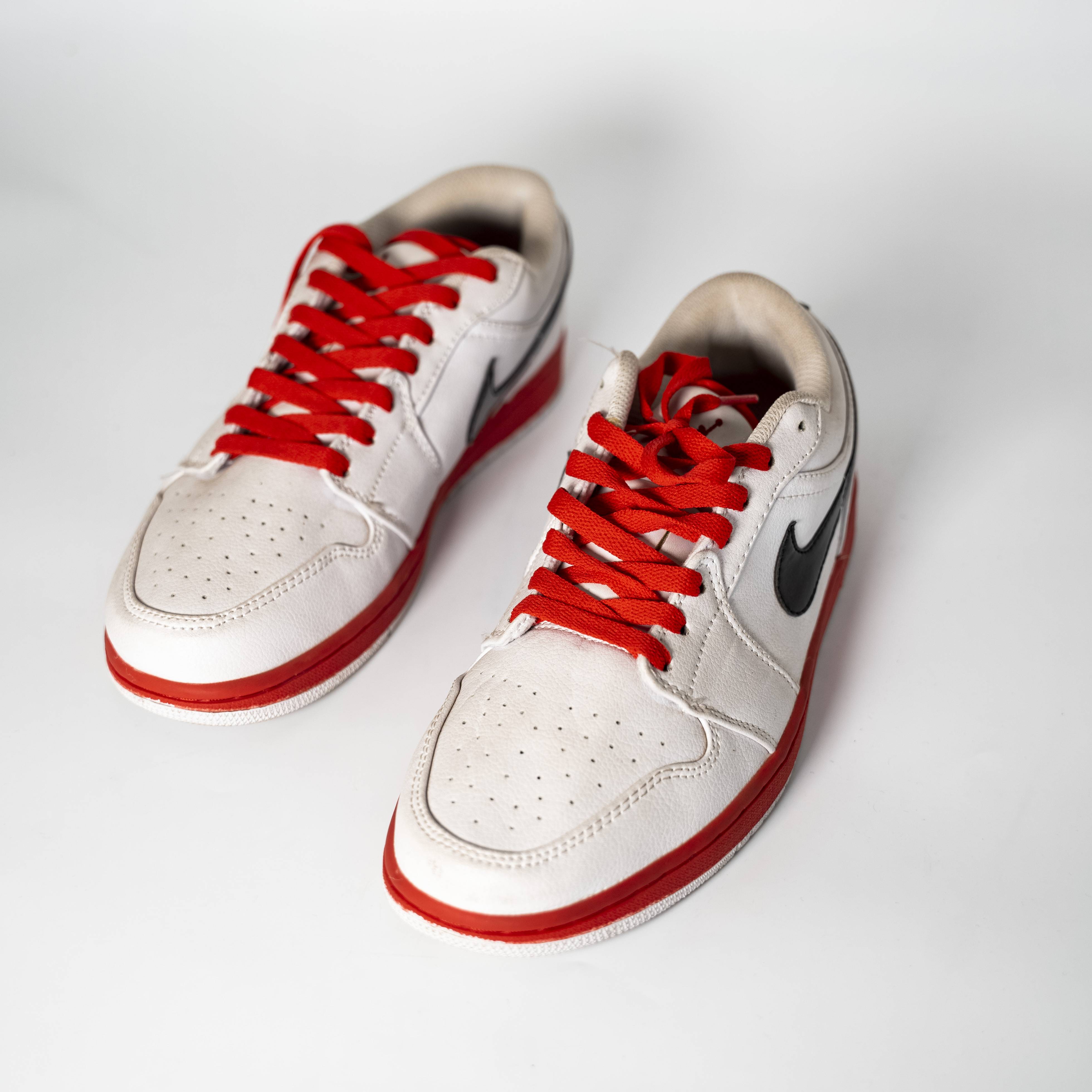 Nike Air Jordan 1 Low in White/Red with Black Swoosh